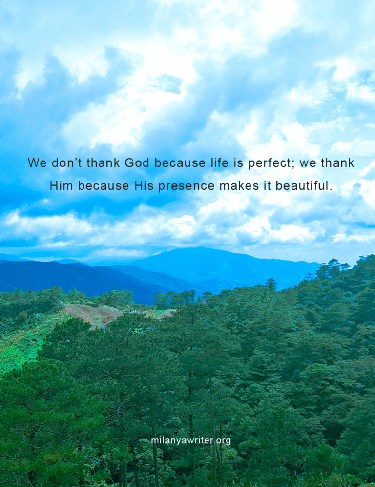 A beautiful mountain with trees under a clear blue sky, featuring the quote: “We don't thank God because life is perfect; we thank Him because His presence makes it beautiful.”