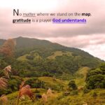 Handwritten spiritual quote saying “No matter where we stand on the map, gratitude is a prayer God understands” on a mountain background representing gratitude journaling and prayer to God