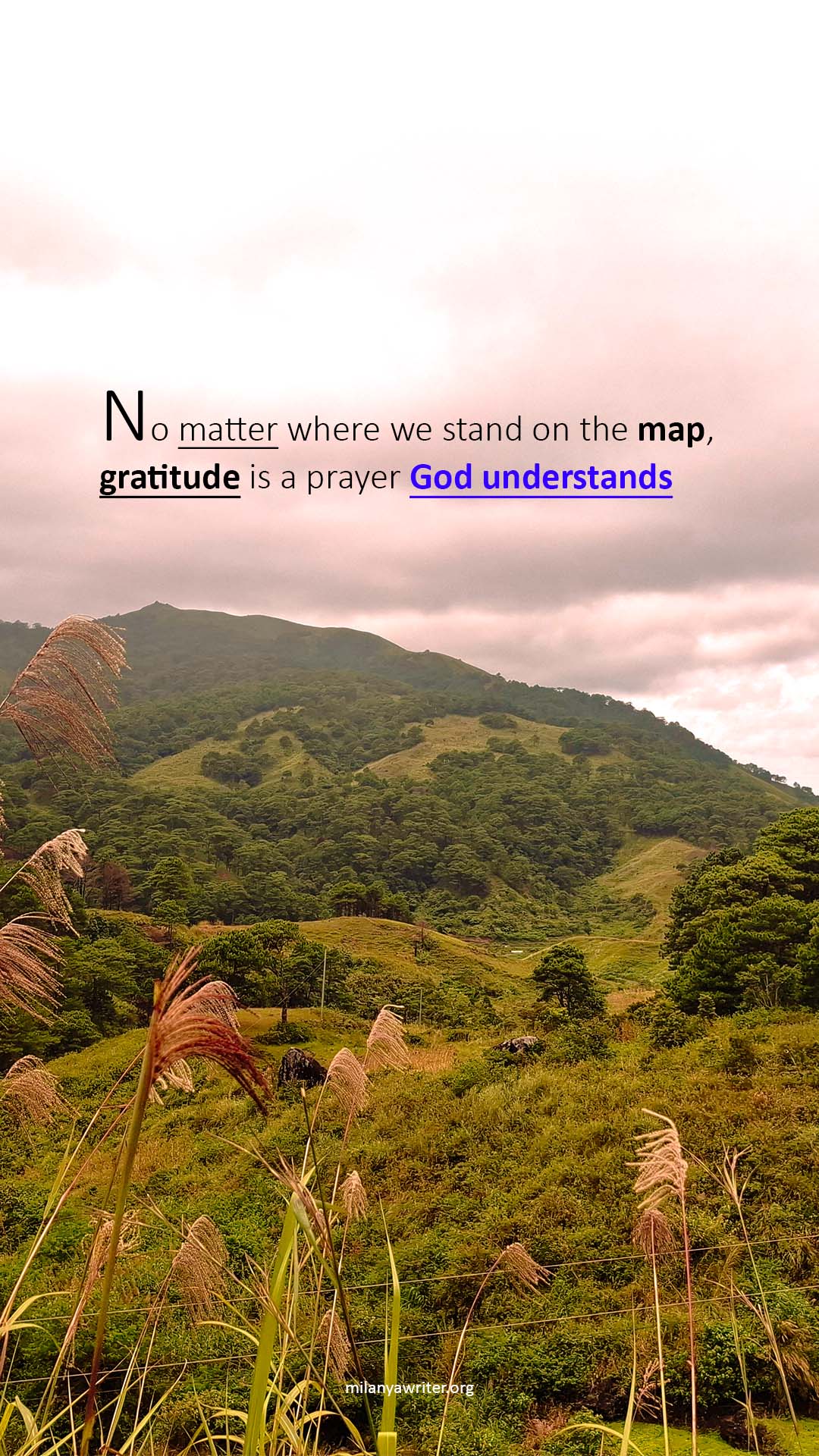 Handwritten spiritual quote saying “No matter where we stand on the map, gratitude is a prayer God understands” on a mountain background representing gratitude journaling and prayer to God